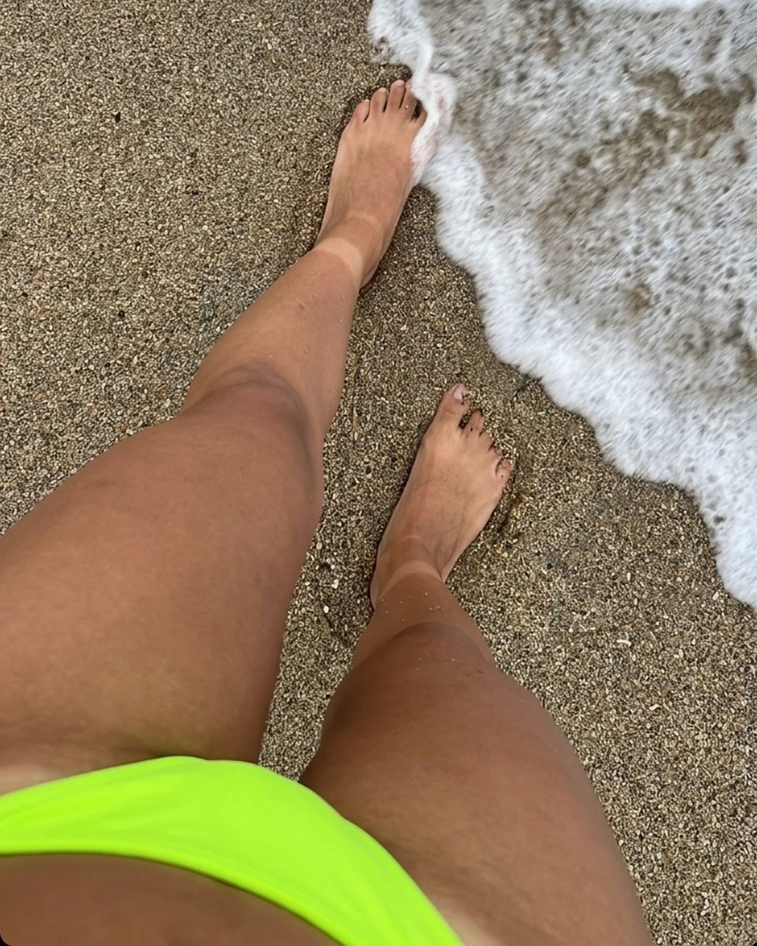 bikini asian — A woman in a vibrant neon green swimwear by the water enjoys a relaxing day at the sunny beach, from adjusting her swimwear to wading in the ocean — 4